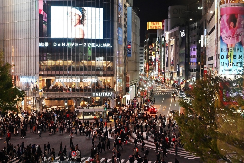 This picture taken on April 6, 2019 shows people walking across the landmark pedestrian crossing in Tokyo's Shibuya district. Charly Tirballeau, AFP/file