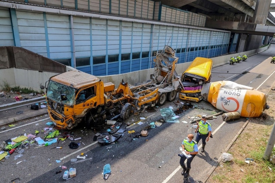 A cement mixer fell off a flyover and hit a school bus in Cheung Sha Wan. The truck driver died and four others were injured in the incident. Dickson Lee, South China Morning Post