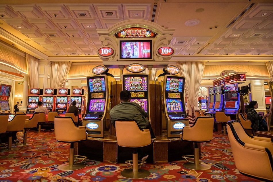 In this photo taken on March 5, 2019, visitors use slot machines in a casino in Macau. Anthony Wallace, AFP/file