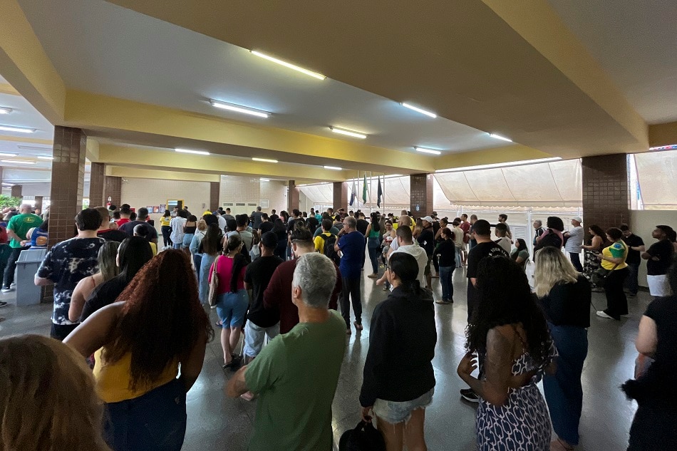 People queue to vote during the legislative and presidential election in a Voting Station at the Taquara neighborhood, west zone of Rio de Janeiro, Brazil, on October 2, 2022. Mauro Pimentel, Agence France-Presse
