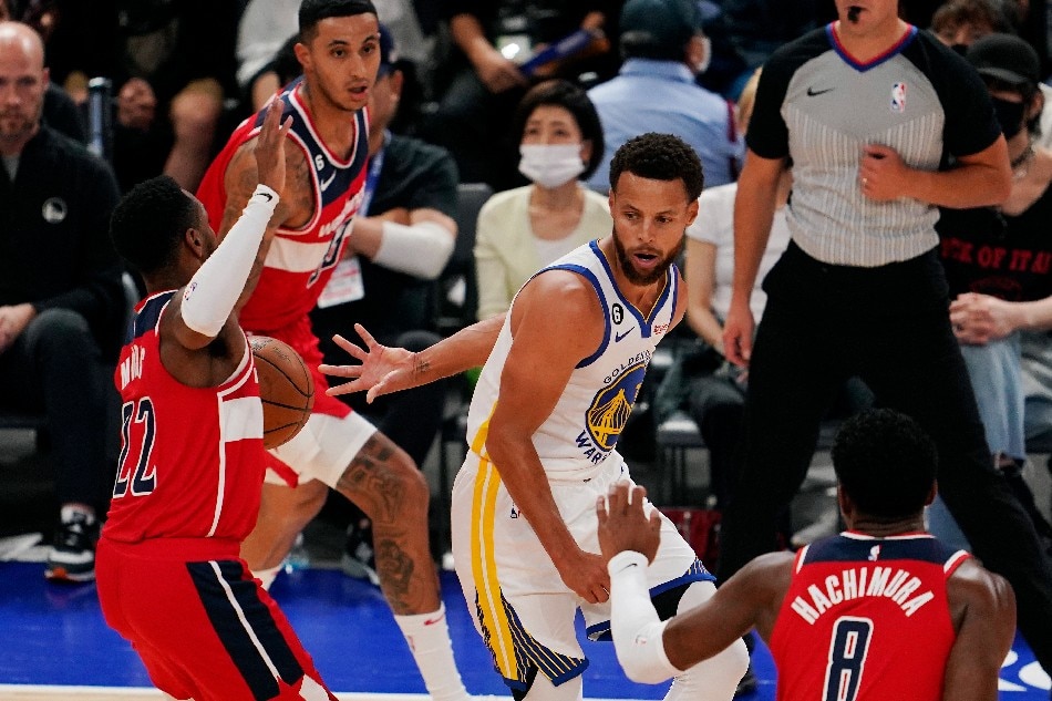 Stephen Curry (C) of the Golden State Warriors passes the ball to a teammate as he is surrounded by players of the Washington Wizards during Game 2 of the NBA Japan Games at Saitama Super Arena in Saitama, north of Tokyo, Japan, 02 October 2022. Kimimasa Mayama, EPA-EFE