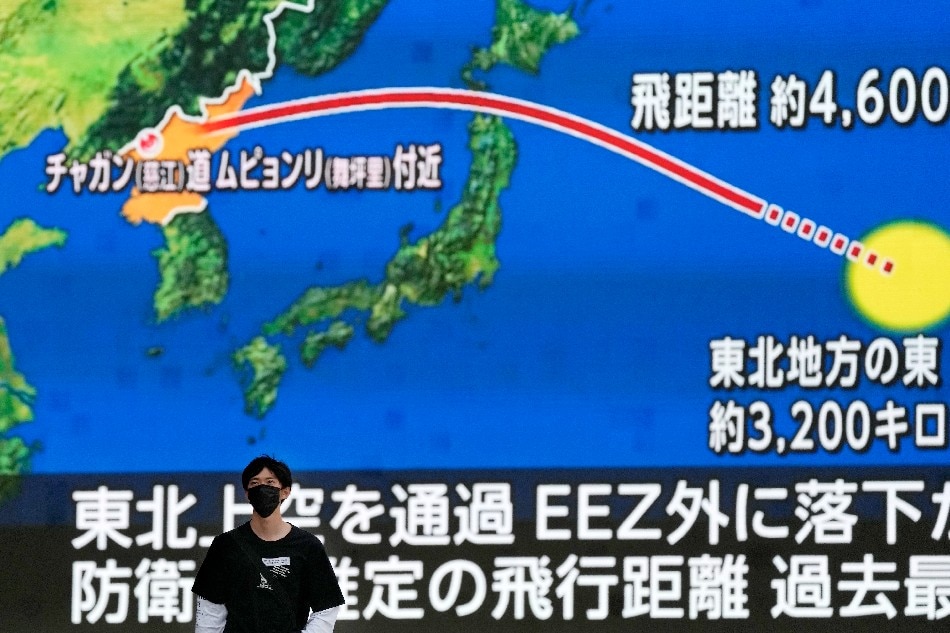 A pedestrian walks under a huge screen displaying news reporting North Korea's launching missile, with the vector of the missile on a map, in Tokyo, Japan, 04 October 2022. North Korea launched a ballistic missile over Japan to the Pacific Ocean, exclusive economic zone (EEZ) of Japan, about 3,000km east of Japan. Japan issued the warning J-Alert to citizens after the missile launch. The display shows the vector of the North Korean missile from North Korea to the EZZ in the Pacific Ocean. EPA-EFE/KIMIMASA MAYAMA