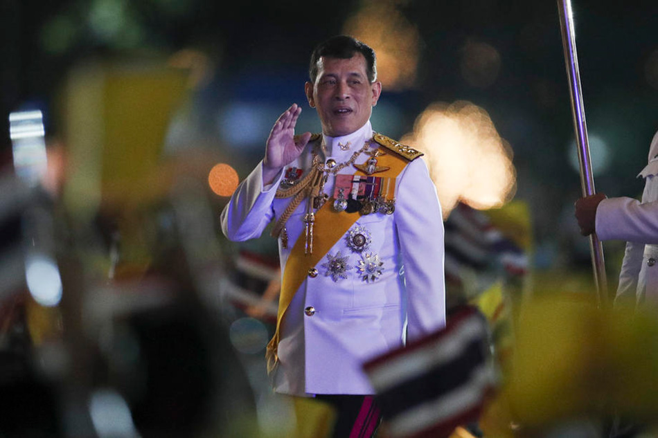 Thai King Maha Vajiralongkorn Bodindradebayavarangkun waves at well-wishers during a ceremony in remembrance of late Thai King Bhumibol Adulyadej