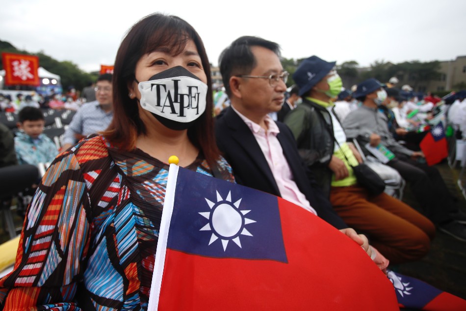 A participant wearing a mask reading 'Taipei' holds a Taiwanese flag during Taiwan's National Day celebrations outside the Presidential Palace in Taipei, Taiwan, October 10, 2022. Taiwan's National day, also known as Double Ten Day, is celebrated annually on October 10. Daniel Ceng Shou Yi, EPA-EFE.