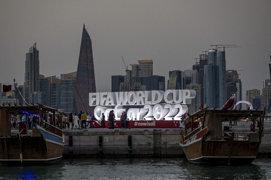People gather in front large sign at the Corniche area in Doha, Qatar, late 15 November 2022. The FIFA World Cup Qatar 2022 will take place from 20 November to 18 December 2022 in Qatar. Martin Divisek, EPA-EFE