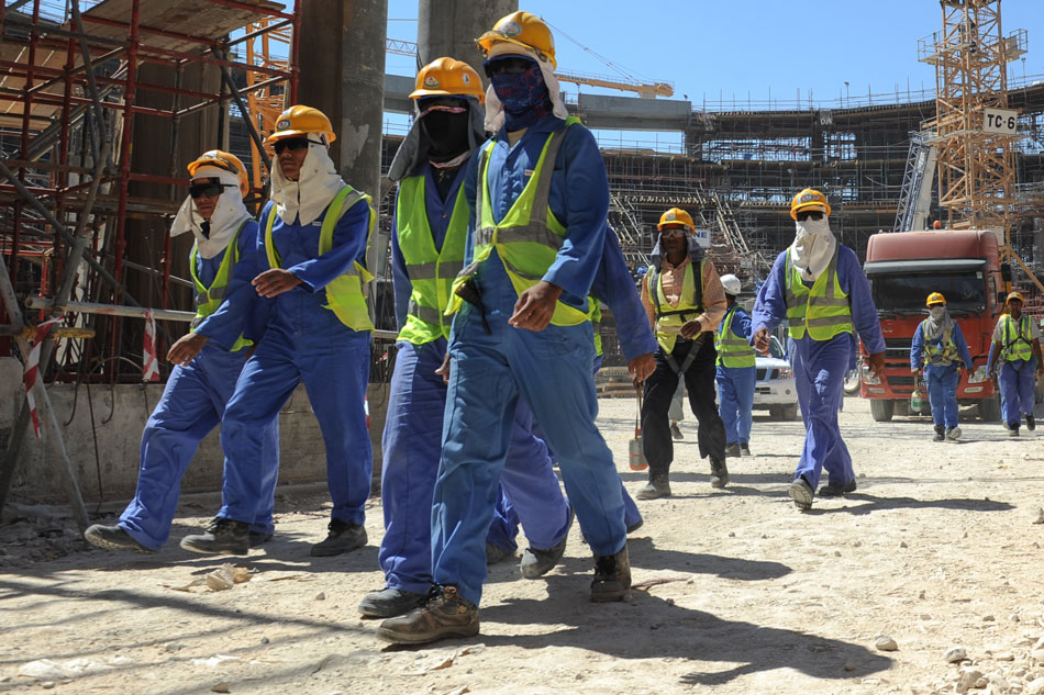 Foreign construction workers leave a construction site in Doha, Qatar, Nov. 19, 2013. EPA stringer/File 