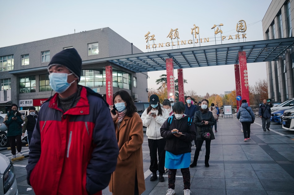 People line up for nucleic acid-based testing (PCR) to detect COVID-19 infection in Chaoyang district in Beijing, China, 14 November 2022. WU HAO, EPA-EFE