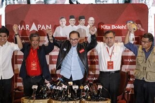 Malaysia's Anwar claims majority after vote, but rival doesn't concede