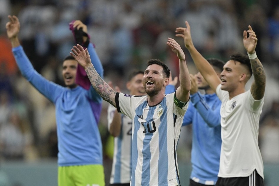 Argentina's forward Lionel Messi reacts with Argentina's forward Lautaro Martinez at the final whistle of the Qatar 2022 World Cup Group C football match between Argentina and Mexico at the Lusail Stadium in Lusail, north of Doha. Juan Mabromata, AFP