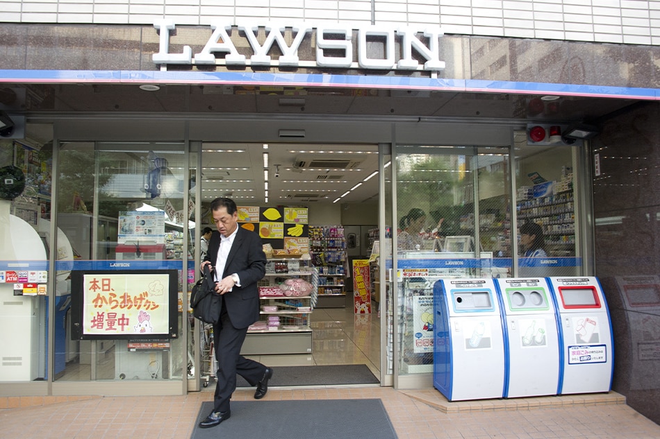 A Japanese businessman exits a Lawson convenience store in downtown Tokyo, Japan, 21 June 2011. EPA/EVERETT KENNEDY BROWN