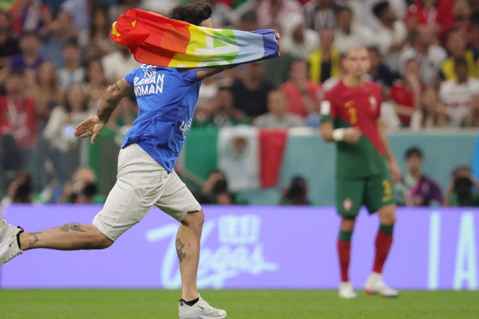 A pitch invader waves a rainbow flag during the FIFA World Cup 2022 group H soccer match between Portugal and Uruguay at Lusail Stadium in Lusail, Qatar, 28 November 2022. Abir Sultan, EPA-EFE