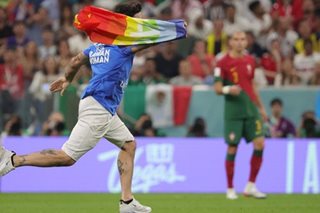 Man with rainbow flag invades pitch during World Cup match