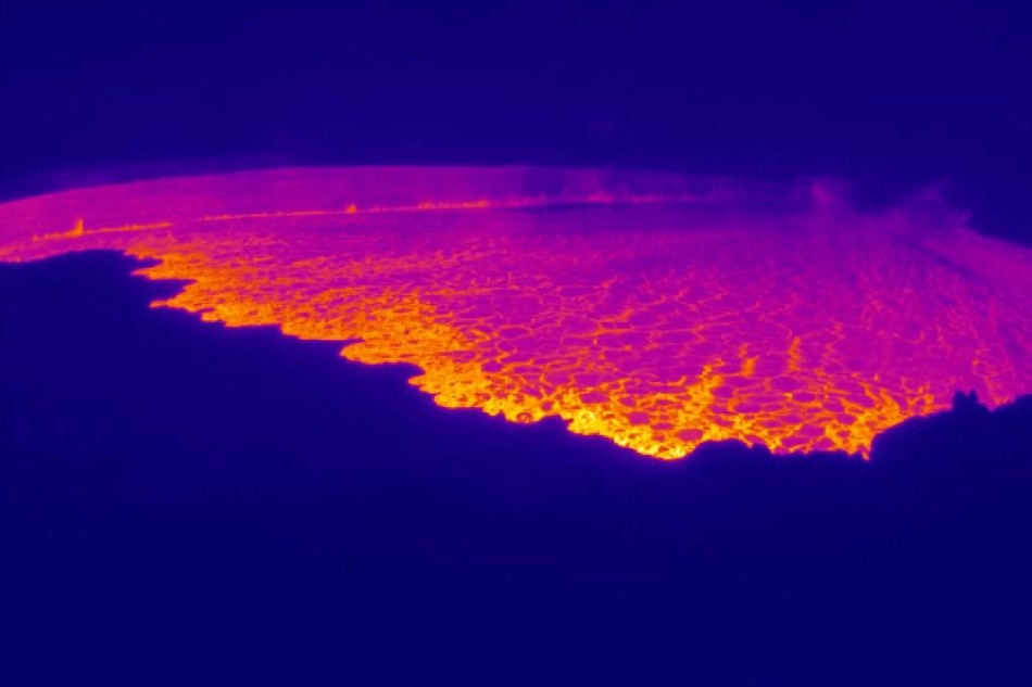 This webcam image released by the US Geological Survey (USGS) on November 28, 2022 courtesy of the National Weather Service, shows the lava in the summit caldera of Mauna Loa in Hawaii, which is erupting for the first time in nearly 40 years. Hawaii's Mauna Loa, the largest active volcano in the world, has erupted for the first time in nearly 40 years, US authorities said, as emergency crews went on alert early Monday.  Handout / US Geological Survey / AFP