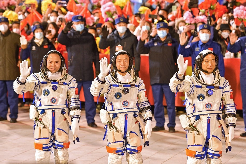 Taikonauts Fei Junlong (R), Deng Qingming (C), and Zhang Lu of the Shenzhou-15 manned space mission wave during a see-off ceremony at the Jiuquan Satellite Launch Center in Jiuquan, China, 29 November 2022. The construction of China's space station will be officially completed during the six-month mission. EPA-EFE/XINHUA / Liu Lei
