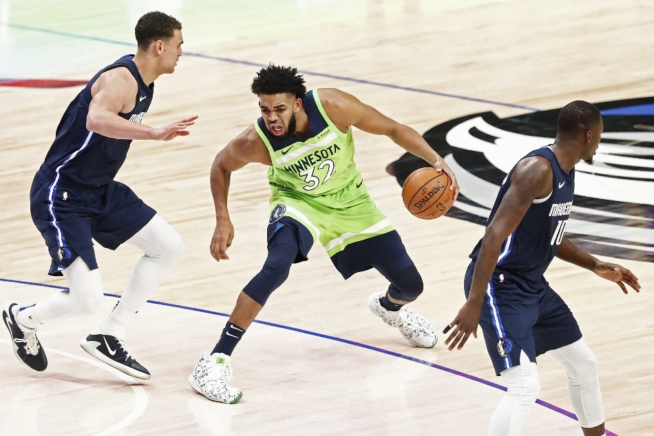 Minnesota Timberwolves player Karl-Anthony Towns (C) drives against Dallas Mavericks player Dwight Powell (L) of Canada in the second half of their NBA basketball game at the American Airlines Center in Dallas, Texas, USA, 04 December 2019. Larry W. Smith, EPA-EFE