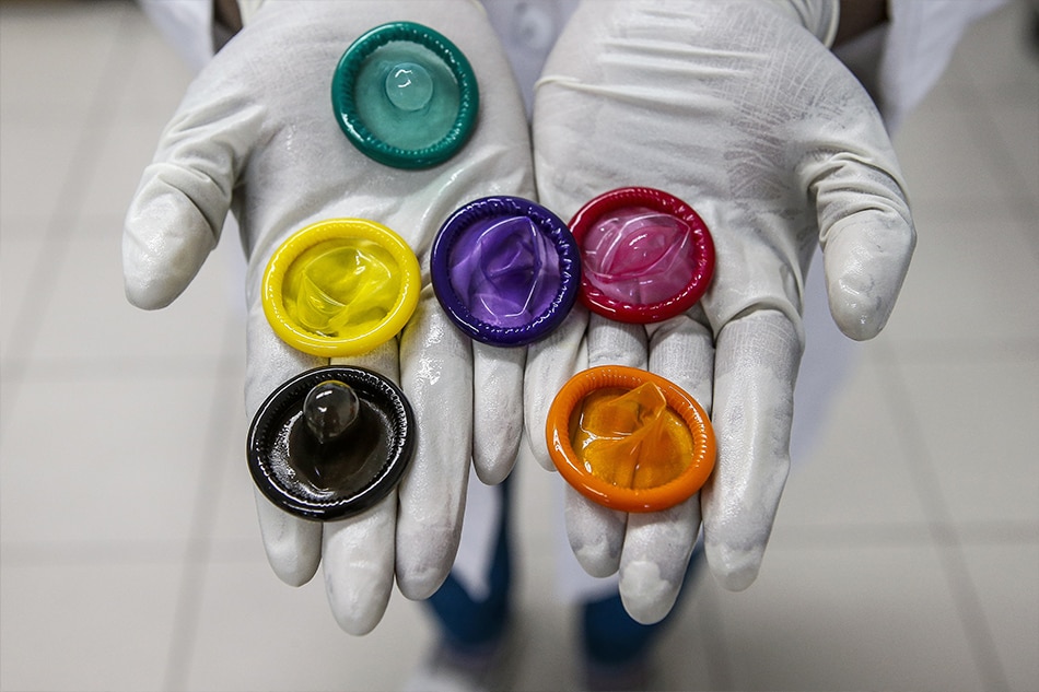  worker holds a variety of colored condoms at the Karex condom factory in Port Klang, Malaysia, 17 January 2015 (reissued 27 November 2018). The French Health Ministry on 27 November 2018 announced that France is to reimburse the costs of prescribed condoms bought at pharmacies from 10 December 2018 on. EPA-EFE/AZHAR RAHIM/FILE