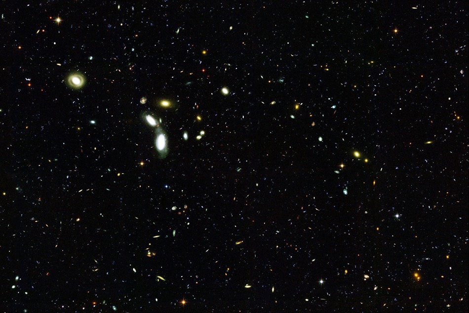 Observatories continue to reach farther back in time to study the evolution of stars and galaxies. Chandra X-ray Observatory and the Hubble Space Telescope's Advanced Camera for Surveys looked back billions of years to see the first galaxies shown in this release photo on June 18, 2003. EPA PHOTO/EPA/NASA/ANN FILED/FILE