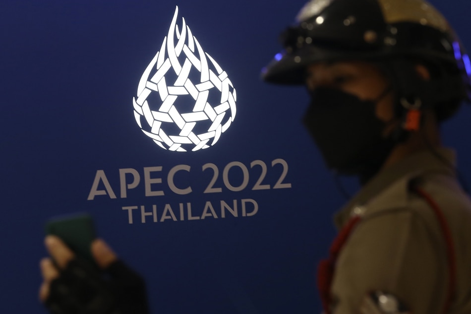 Thai policeman uses a mobile phone to take a photo of the logo for the Asia-Pacific Economic Cooperation (APEC) 2022 during the launching ceremony of APEC 2022 Thailand logo in Bangkok, Thailand, 18 November 2021. EPA-EFE/Narong Sangnak 
