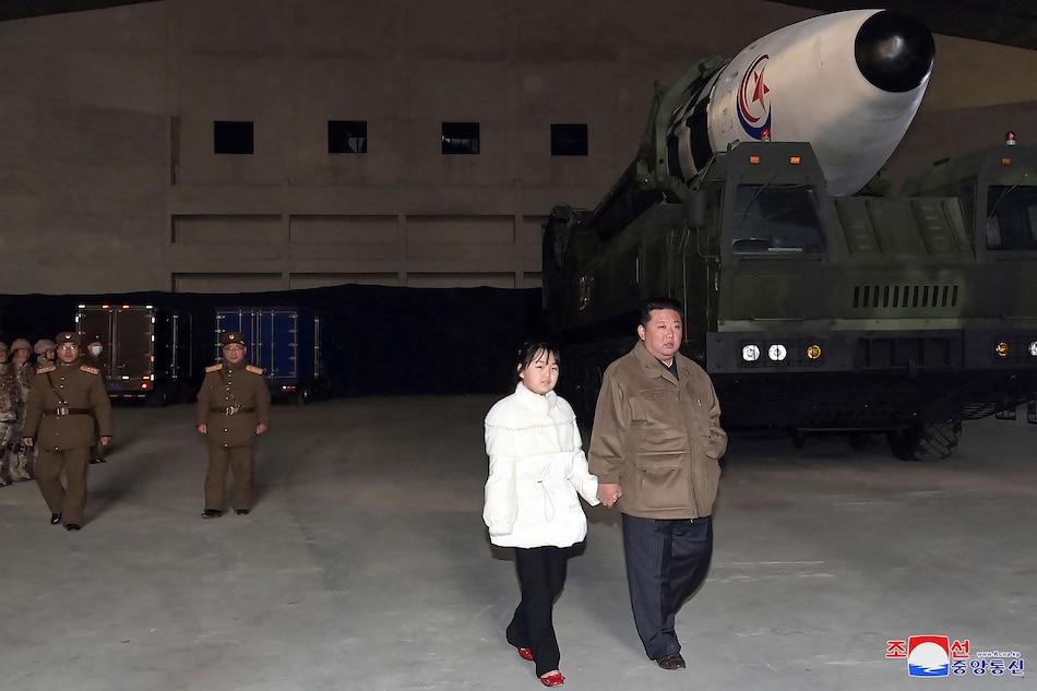 This picture taken on Nov. 18, 2022 and released from North Korea's official Korean Central News Agency (KCNA) on Nov. 19, 2022 shows North Korea's leader Kim Jong Un (R) walking with his daughter as he inspects a new intercontinental ballistic missile (ICBM) 'Hwasong Gun 17', ahead of its launch at Pyongyang International Airport. KCNA via KNS/AFP