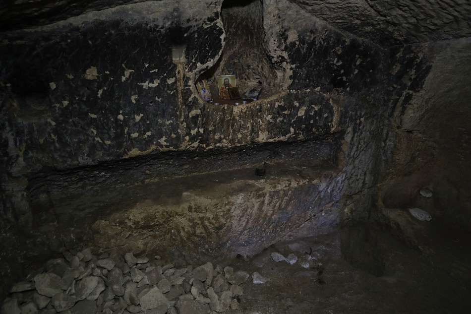 Christian religious icons left by recent visitors are placed in a niche of a Second Temple-period burial cave in Lachish Forest, 20 December 2022, during excavations on the site of a grave estate from the days of the Second Temple (about 2,000 years ago), that was discovered in the South of Israel. According to Israel Antiques Authority (IAA) archaeologists, the burial cave that continued to be used in the Byzantine and Early Islamic periods, became known as the 