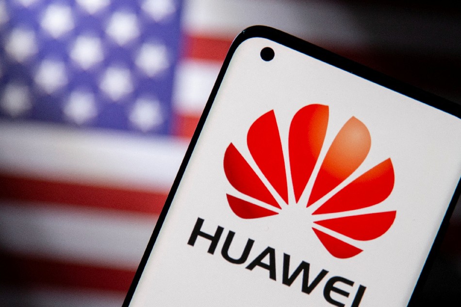 Smartphone with a Huawei logo is seen in front of a U.S. flag in this illustration taken September 28, 2021. Dado Ruvic, Reuters/Illustration/File Photo
