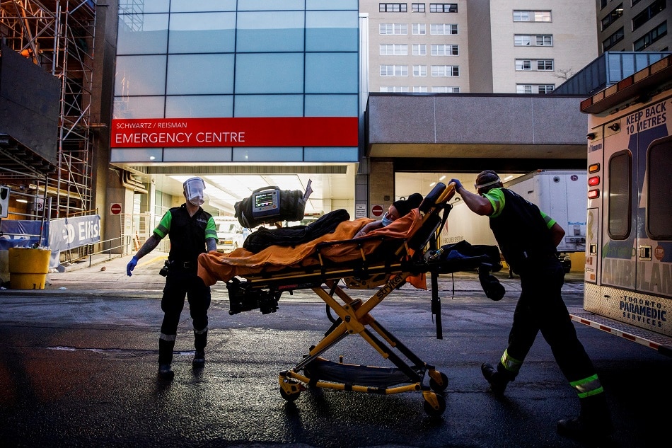 Ambulance crew members deliver a patient at Mount Sinai Hospital, as officials warned of a 