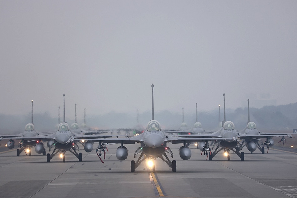 12 F-16V fighter jets perform an elephant walk during an annual New Year's drill in Chiayi, Taiwan, January 5, 2022. Ann Wang, Reuters