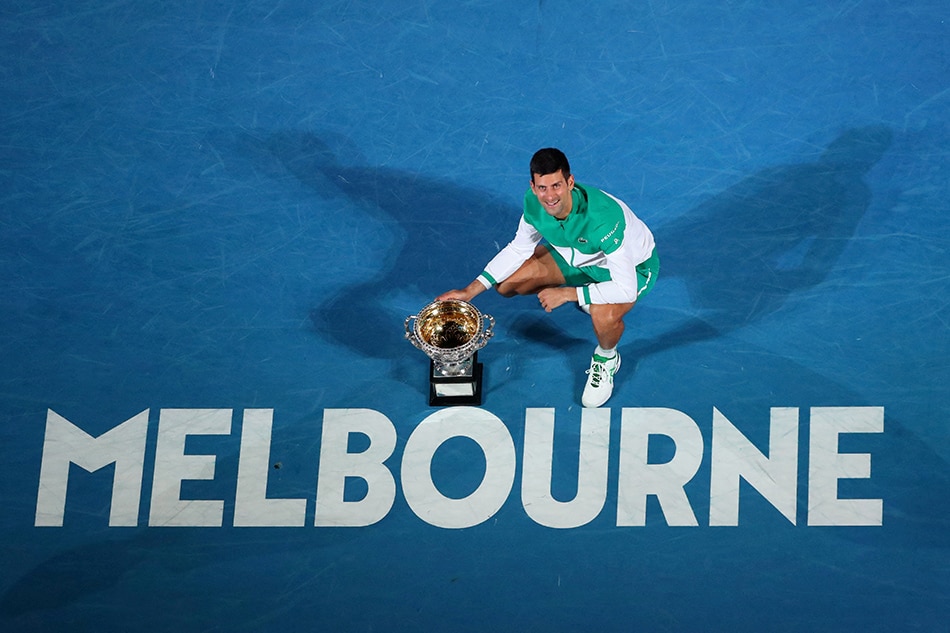 Djokovic celebrates with the trophy after winning his final match against Russia's Daniil Medvedev at the Australian Open in Melbourne on February 21, 2021. Kelly Defina, Reuters/file