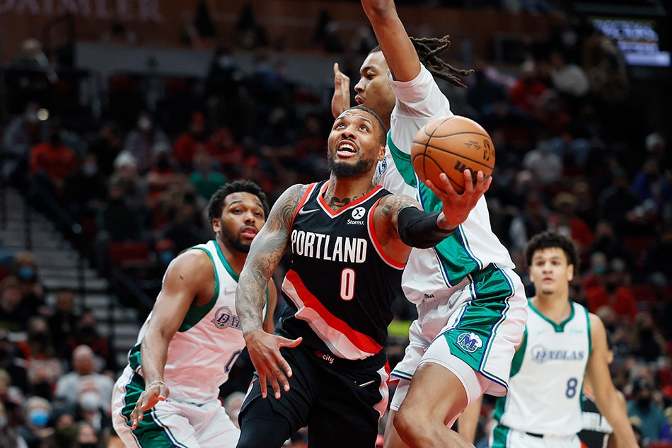 Portland point guard Damian Lillard drives to the basket under pressure from Dallas center Moses Brown in their game on December 27, 2021. Soobum Im, USA Today Sports/Reuters