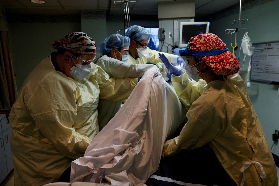 Medical staff treat a coronavirus disease patient in their isolation room on the ICU at Western Reserve Hospital in Cuyahoga Falls, Ohio, January 4, 2022. Shannon Stapleton, Reuters/File Photo