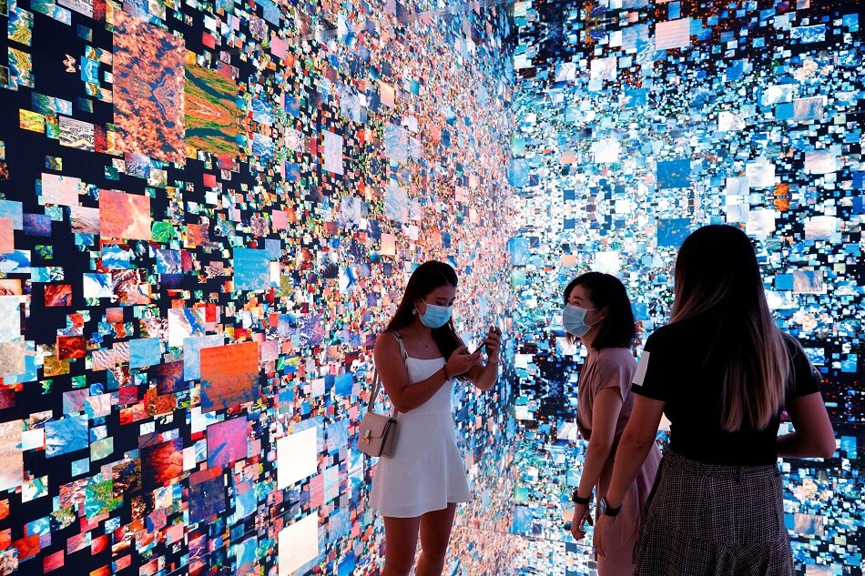 Visitors are pictured in front of an immersive art installation that will be converted into NFT and auctioned online at Sotheby's, at the Digital Art Fair, in Hong Kong September 30, 2021. Tyrone Siu, Reuters/file