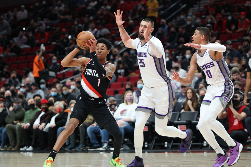 Portland Trail Blazers guard Anfernee Simons (1) passes the ball off against Sacramento Kings center Alex Len (25) and Kings' guard Tyrese Haliburton (0) in the first half at Moda Center. Jaime Valdez, USA TODAY Sports/Reuters.