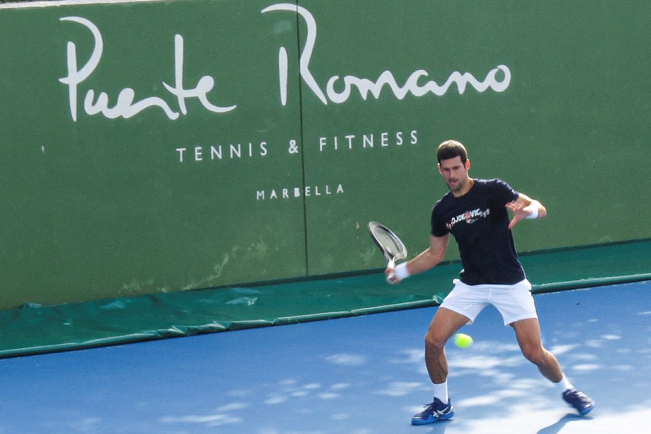Serbian tennis player Novak Djokovic trains at Puente Romano Tennis Club in Marbella, Spain, January 2, 2022. Picture taken January 2, 2022. KMJ-GTRES/Handout via Reuters.