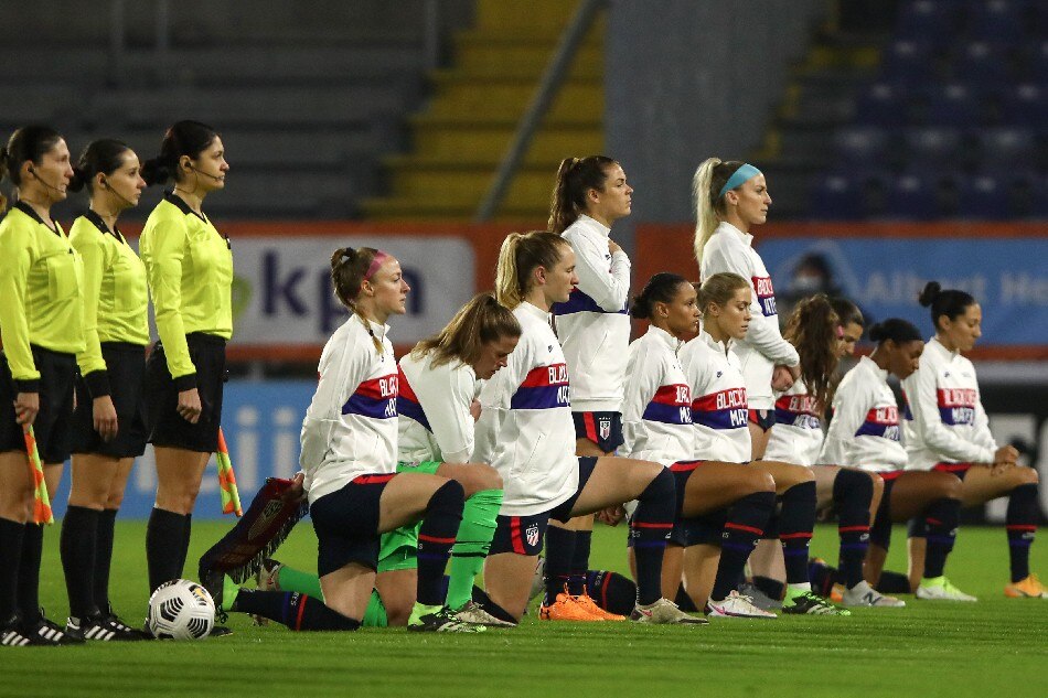 United States' players, most kneeling against racism, listen to their national anthem ahead of the women's friendly football match between the Netherlands and the United States of America (USA), at the Rat Verlegh Stadium in Breda, the Netherlands, on November 27, 2020. File photo. Dean Mouhtaropoulos, AFP