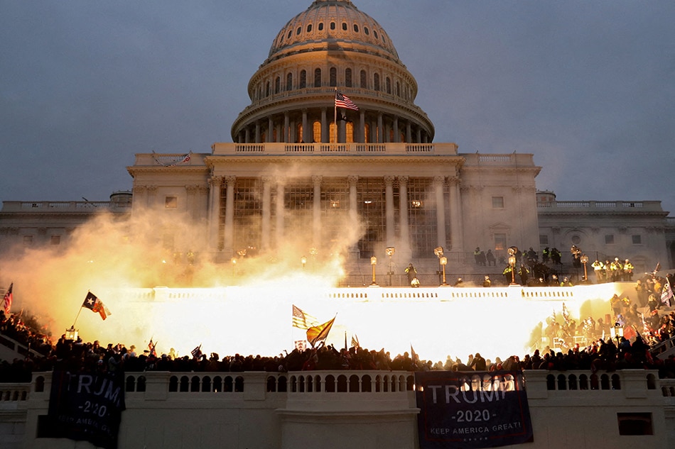 An explosion caused by a police munition is seen while Trump supporters riot at the US Capitol building in Washington, U.S., January 6, 2021. Leah Millis, Reuters/file