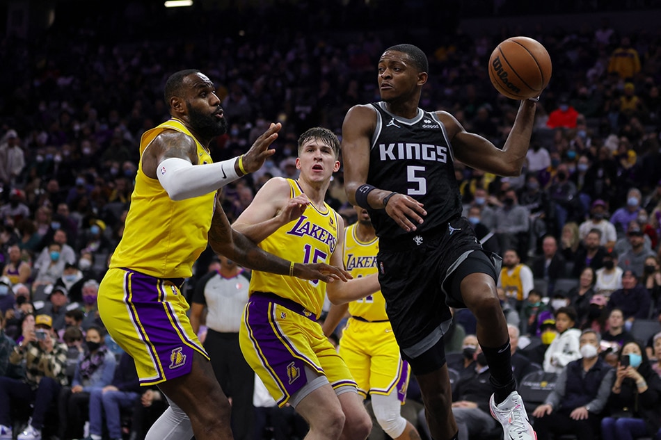 Sacramento Kings guard De'Aaron Fox (5) passes the ball against Los Angeles Lakers forward LeBron James (6) during the fourth quarter at Golden 1 Center. Sergio Estrada, USA TODAY Sports/Reuters