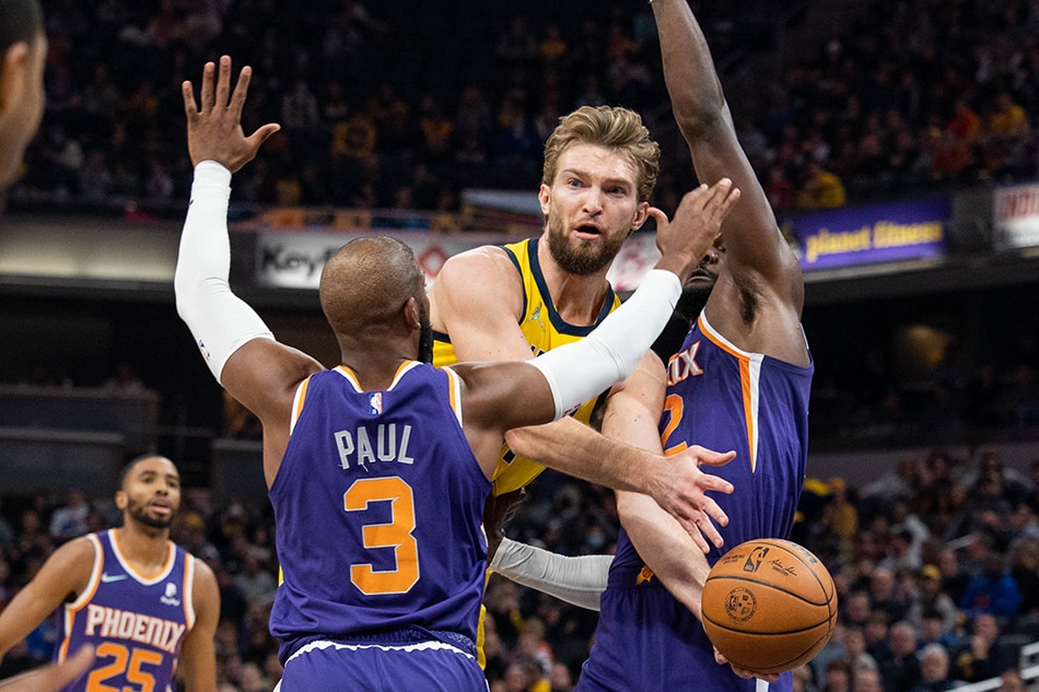 Pacers forward Domantas Sabonis passes, as Phoenix teammates Chris Paul and Ayton defend in their game on January 14, 2022. Trevor Ruszkowski, USA Today Sports/Reuters