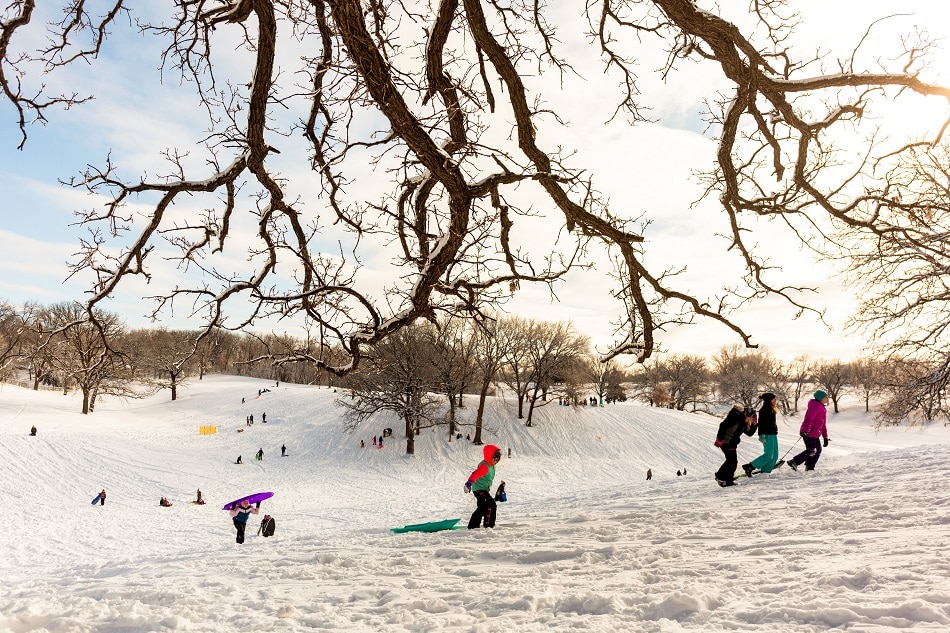 Children sled at Waveland Golf Course after the area accumulated snow from Winter Storm Izzy in Des Moines, Iowa, U.S., January 15, 2022. Rachel Mummey, Reuters