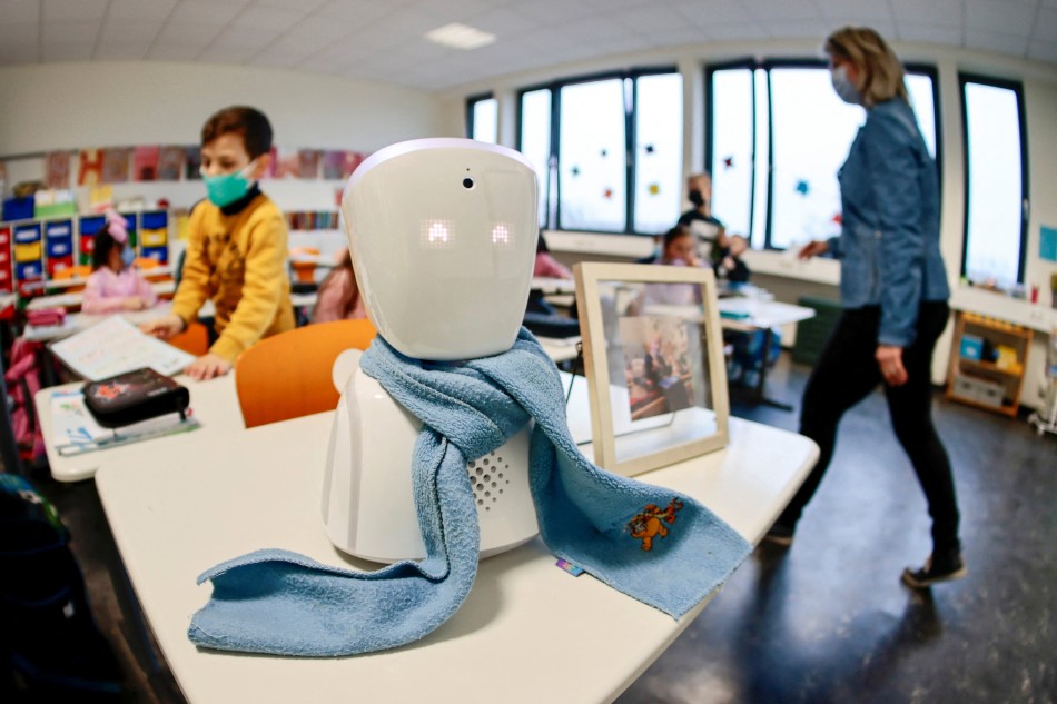 A seven-year-old schoolboy Joshua attends his school lesson via a robot avatar, seen in his classroom, in Berlin, Germany January 13, 2022. Picture taken January 13, 2022. Hannibal Hanschke, Reuters