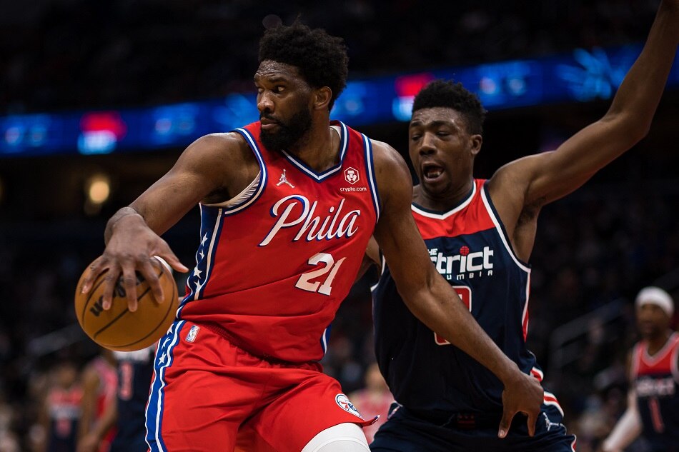 76ers center Joel Embiid handles the ball as Washington center Thomas Bryant defends during their game January 17, 2022: Scott Taetsch, USA Today Sports/Reuters