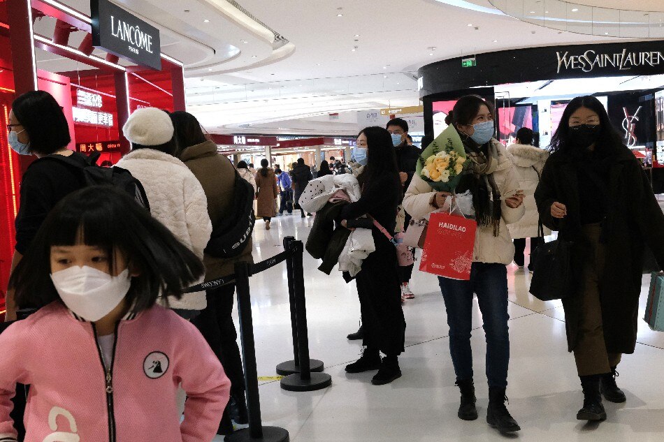 Customers walk inside a shopping mall in Beijing, China January 14, 2022. Picture taken January 14, 2022. Tingshu Wang, Reuters/File