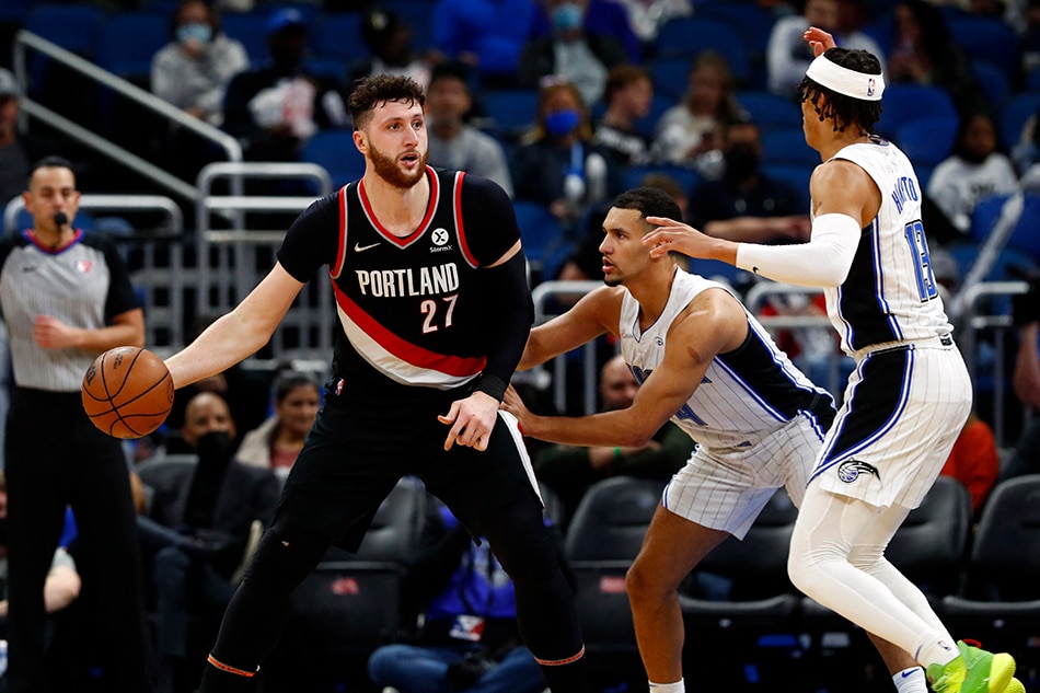 Portland Trail Blazers center Jusuf Nurkic (27) drives to the basket as Orlando Magic guard Jalen Suggs (4) and Orlando Magic guard R.J. Hampton (13) defend during the second half at Amway Center. Kim Klement, USA TODAY Sports/Reuters