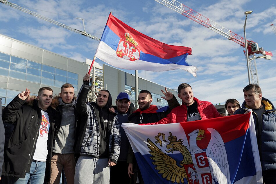 Fans of Serbian tennis player Novak Djokovic hold Serbian flags as they wait for his arrival at Nikola Tesla Airport, after the Australian Federal Court upheld a government decision to cancel his visa to play in the Australian Open, in Belgrade, Serbia, January 17, 2022. Marko Djurica, Reuters