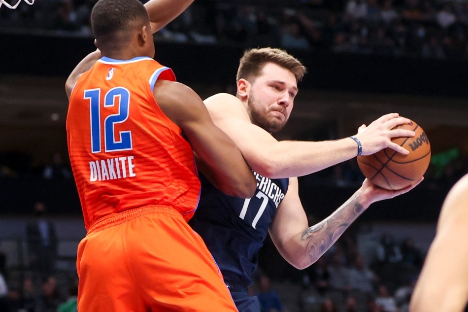 Dallas Mavericks guard Luka Doncic (77) looks to pass as Oklahoma City Thunder forward Mamadi Diakite (12) defends during the second quarter at American Airlines Center. Kevin Jairaj, USA TODAY Sports/Reuters.