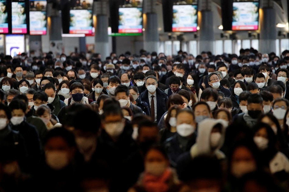 Commuters make their way at a train station in Tokyo, January 17 2022. Kim Kyung-Hoon, Reuters