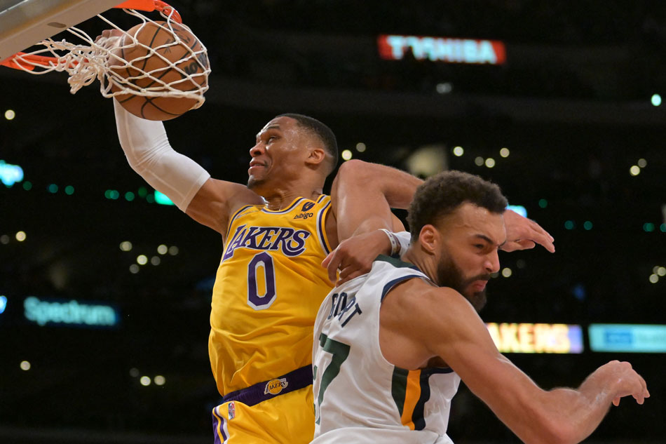 Los Angeles Lakers guard Russell Westbrook (0) dunks over Utah Jazz center Rudy Gobert (27) in the first half of the game at Crypto.com Arena. Jayne Kamin-Oncea, USA TODAY Sports/Reuters.