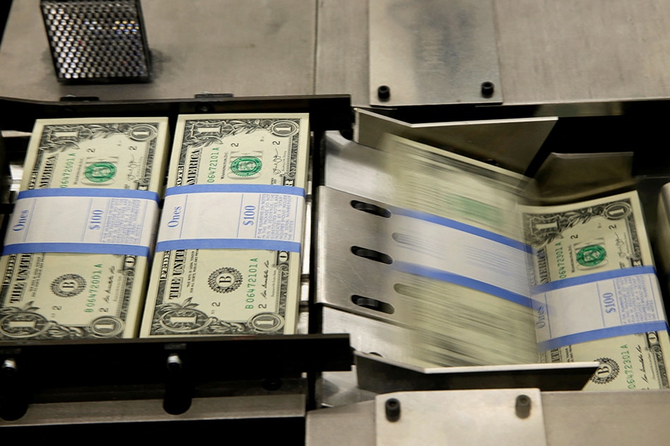 United States one dollar bills are put in packaging bands during production at the Bureau of Engraving and Printing in Washington November 14, 2014. Gary Cameron, Reuters/File Photo
