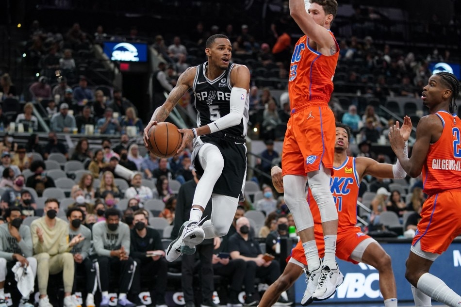 San Antonio Spurs guard Dejounte Murray (5) looks to pass in front of Oklahoma City Thunder center Mike Muscala (33) in the first half at the AT&T Center. Daniel Dunn, USA TODAY Sports/Reuters.