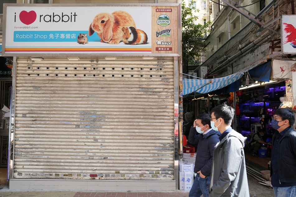 Pedestrians walk past a closed pet shop in Mong Kok district after a hamster cull was ordered to curb the COVID-19 outbreak, in Hong Kong, China, Jan. 19, 2022. Lam Yik, Reuters