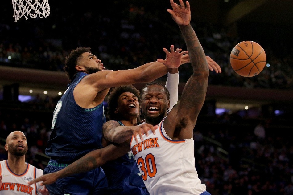 New York Knicks forward Julius Randle (30) is fouled by Minnesota Timberwolves forward Jaden McDaniels (3) as he drives to the basket against McDaniels and center Karl-Anthony Towns (32) during the third quarter at Madison Square Garden. Brad Penner, USA TODAY Sports/Reuters